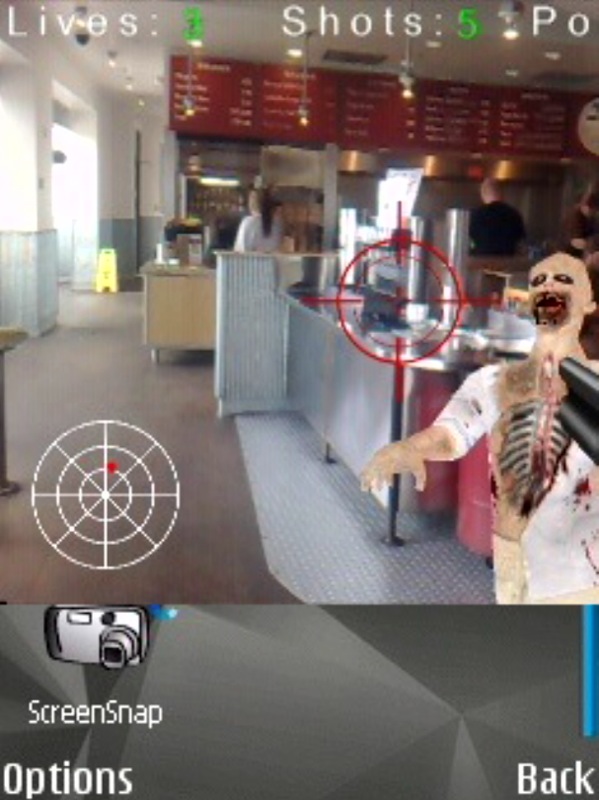 Joueur utilisant son téléphone pour viser un zombie virtuel en réalité augmentée