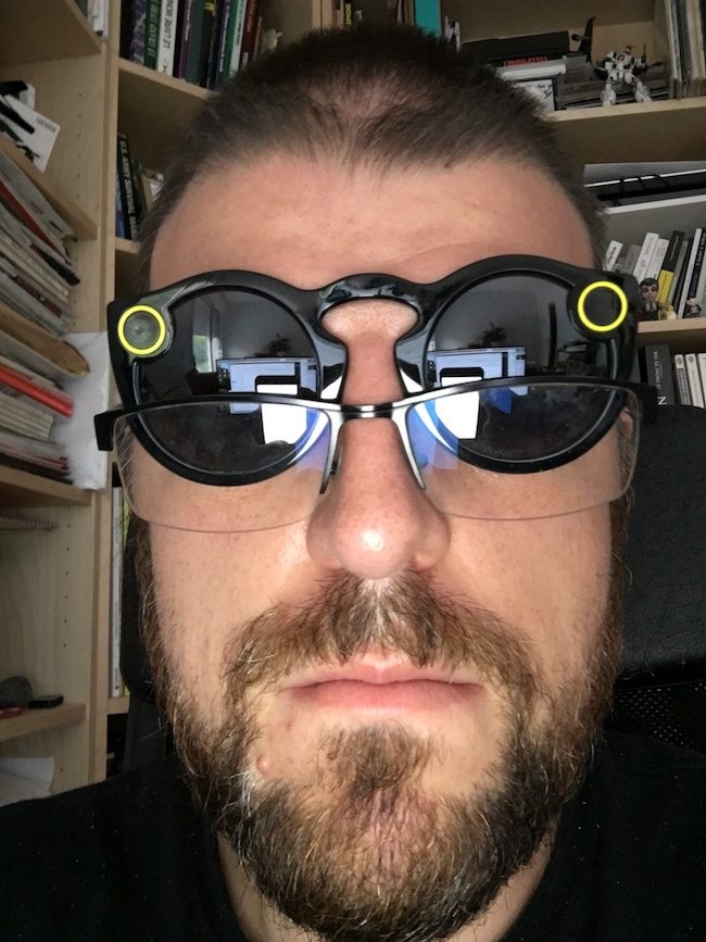 Main appuyant sur le bouton de réinitialisation des lunettes Spectacles de Snapchat