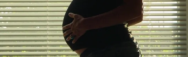 Fœtus dans le ventre de sa mère, avec un écran de téléphone mobile affichant la page Twitter